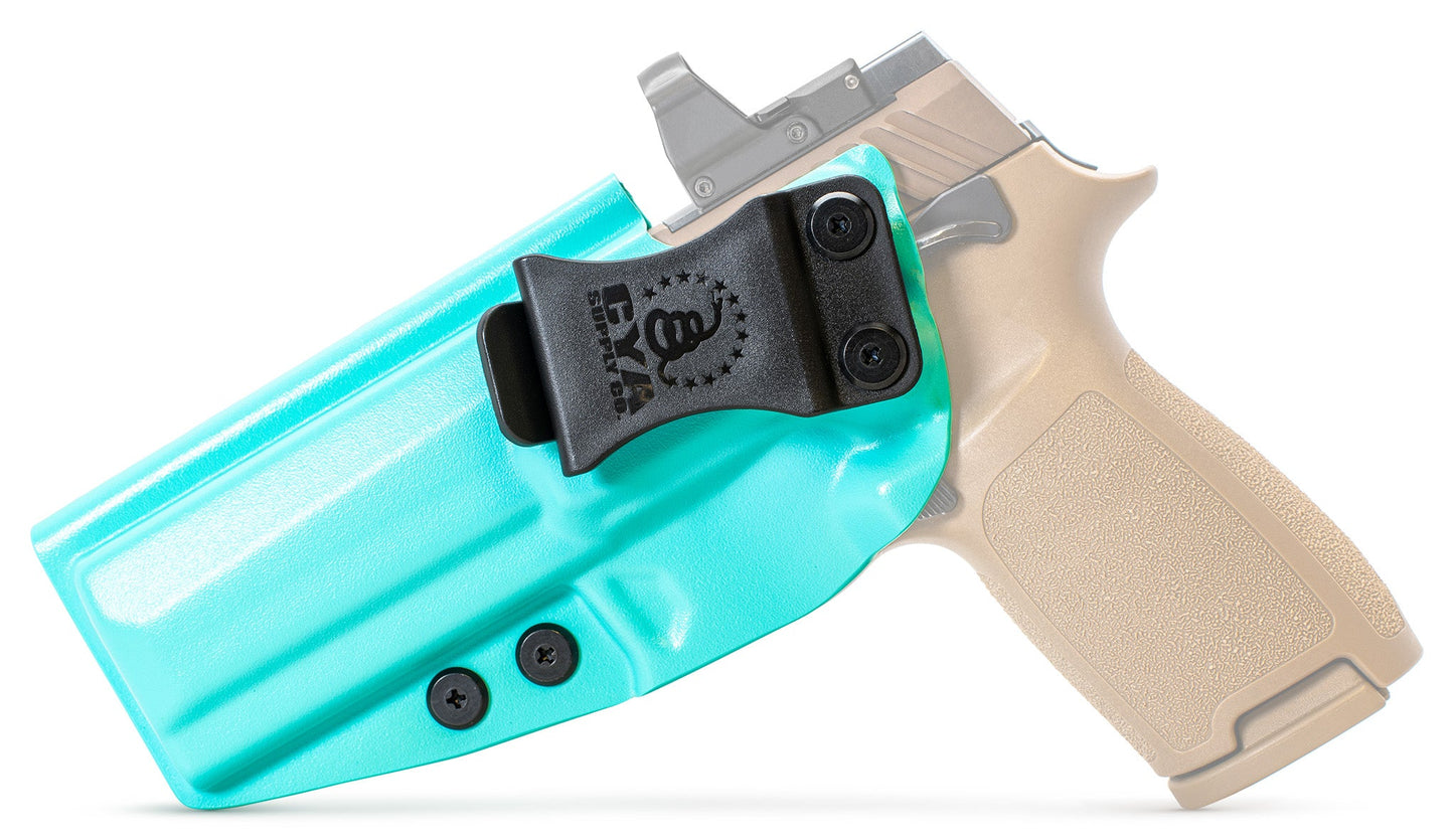 CYA Full size Holster in teal blue with a black clip on a tan sig sauer p320 handgun